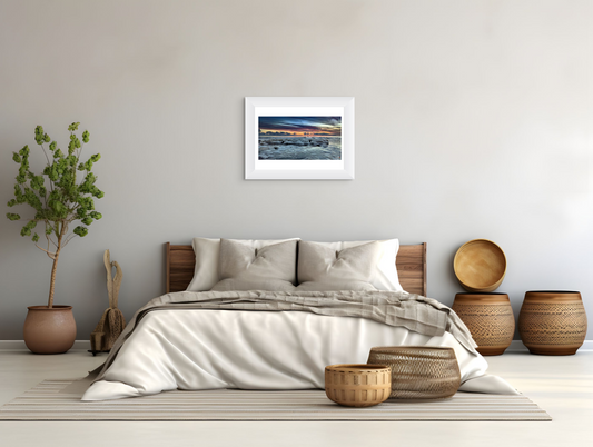 Bedroom with a bed, decorative baskets, and framed artwork on the wall.