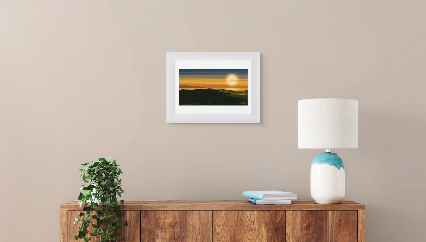 Framed artwork of a sunset over water on a beige wall above a wooden console table.