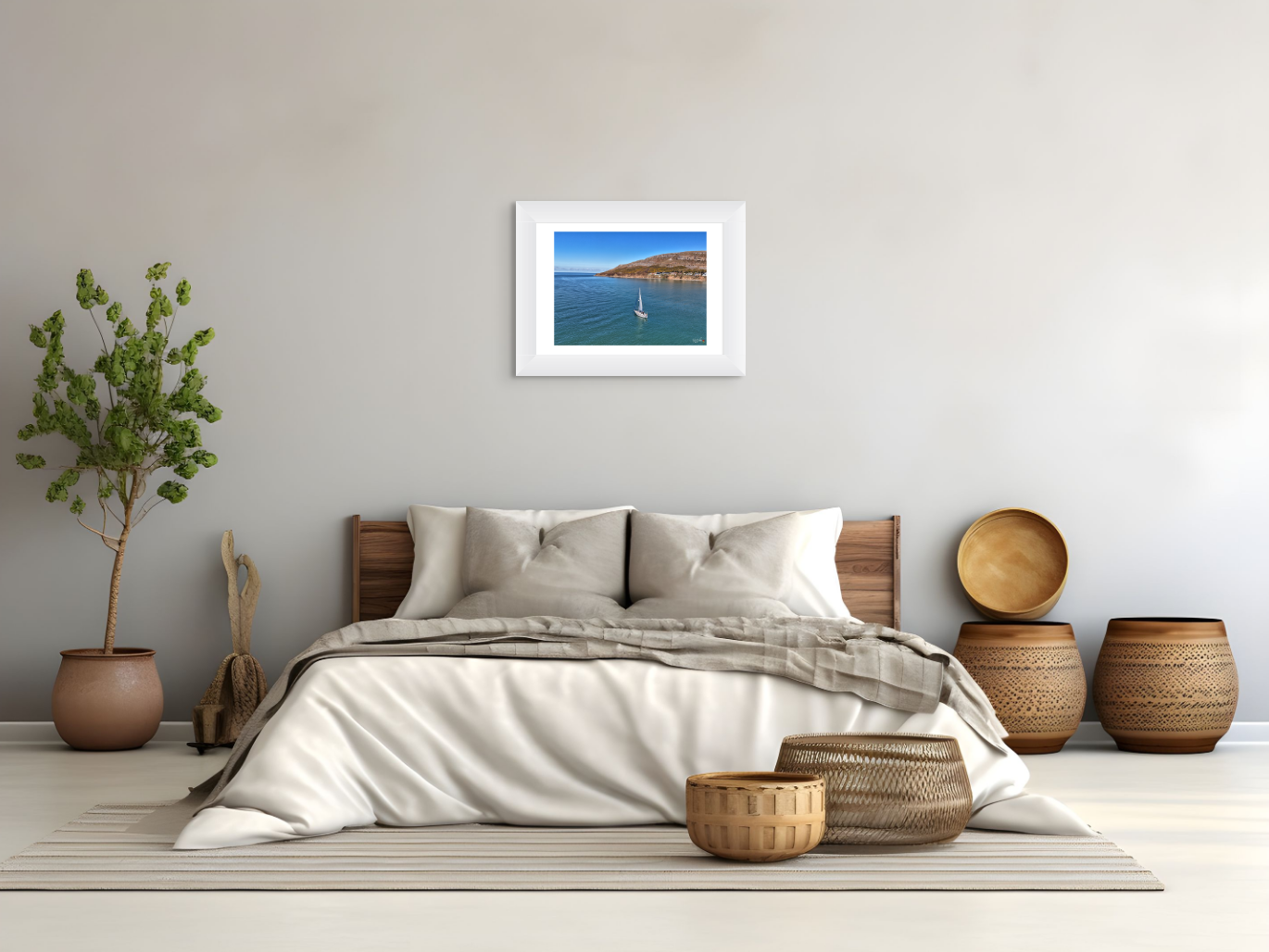 Bedroom with a bed, decorative baskets, and a framed picture of a coastal scene.